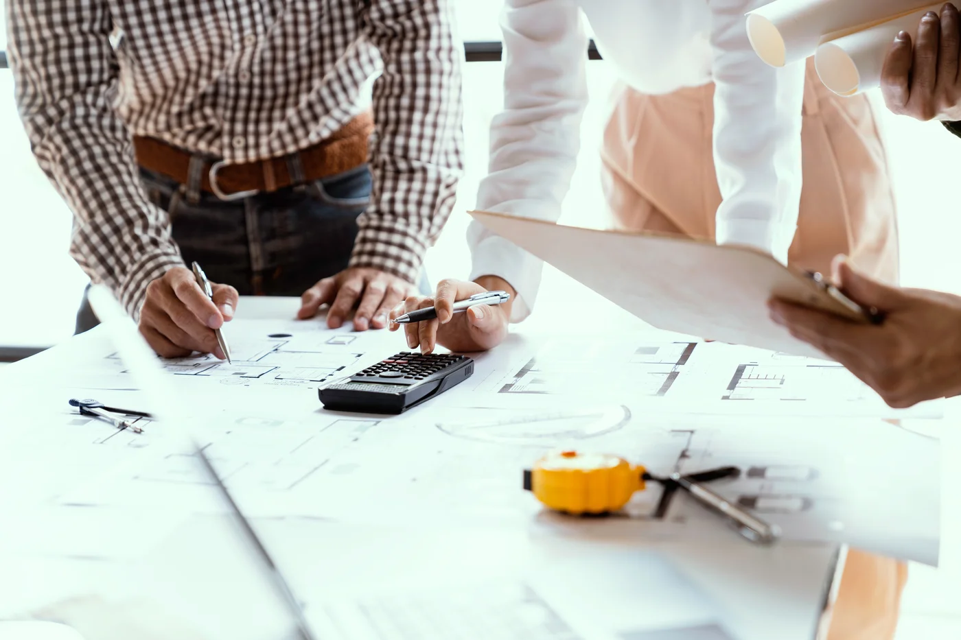 Engineers reviewing project cost documents
